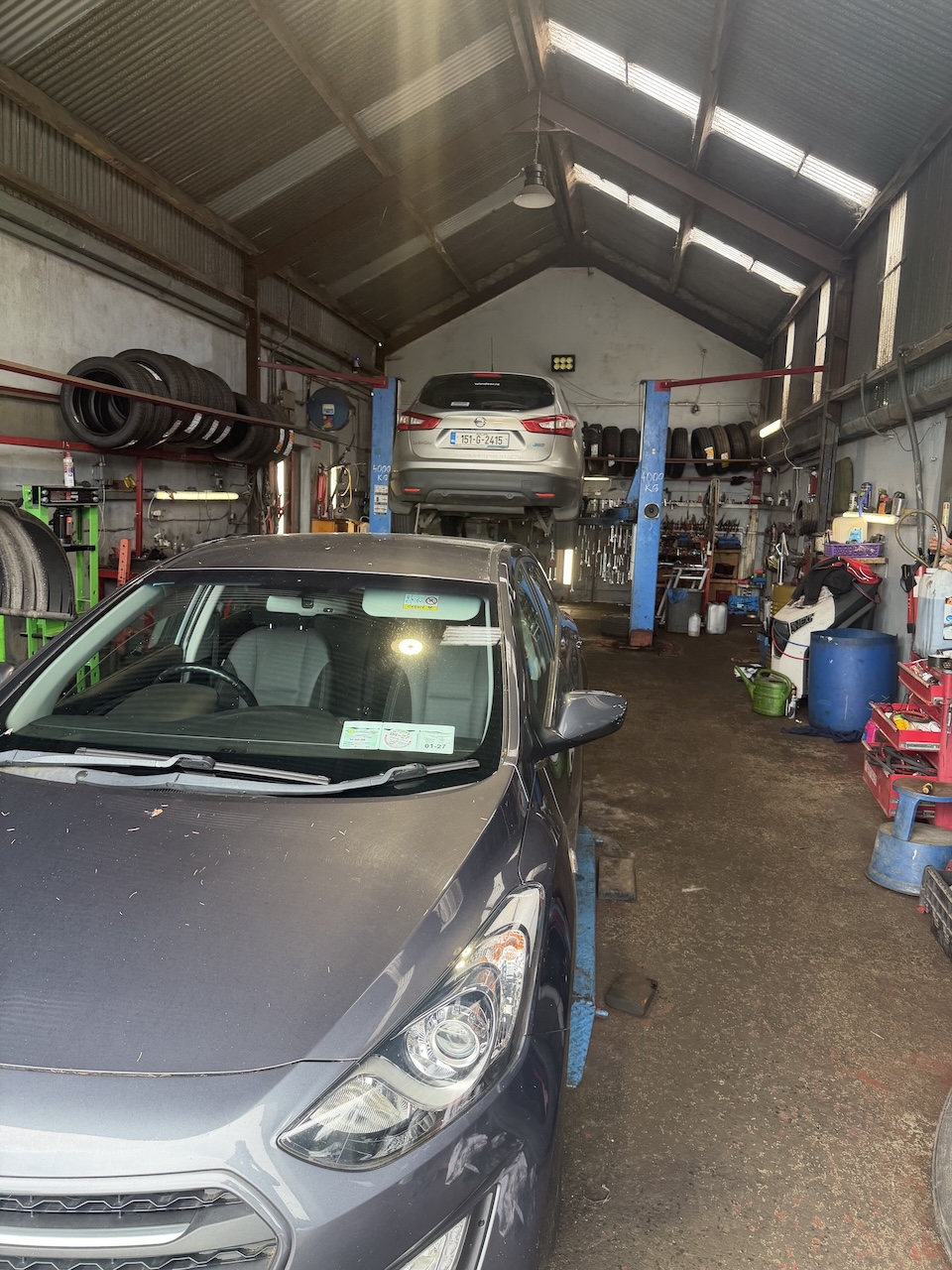 Mechanic servicing a car at C&T Autos